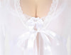 Plus Size White lace garment with a bow detail on a white background