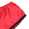 Red satin fabric with black lace trim on a white background