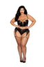 Model wearing a black lingerie set with fishnet stockings on a white background