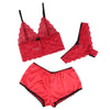 Red lace lingerie set with bra, panties, and garter on a white background