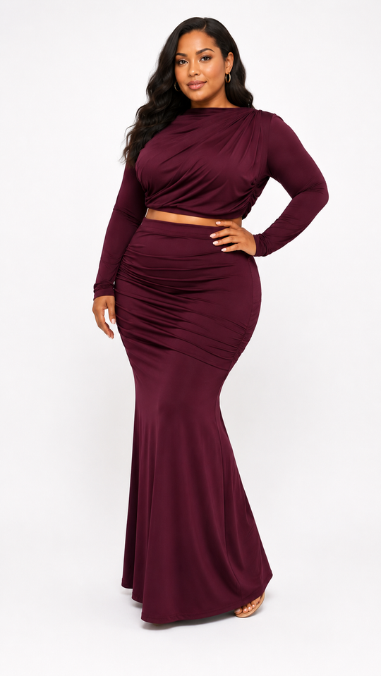 Woman wearing a burgundy long-sleeve dress on a white background
