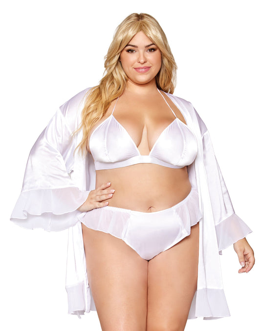 Woman wearing a white lingerie set with a matching robe on a white background