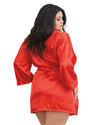 Woman wearing a red satin robe on a white background