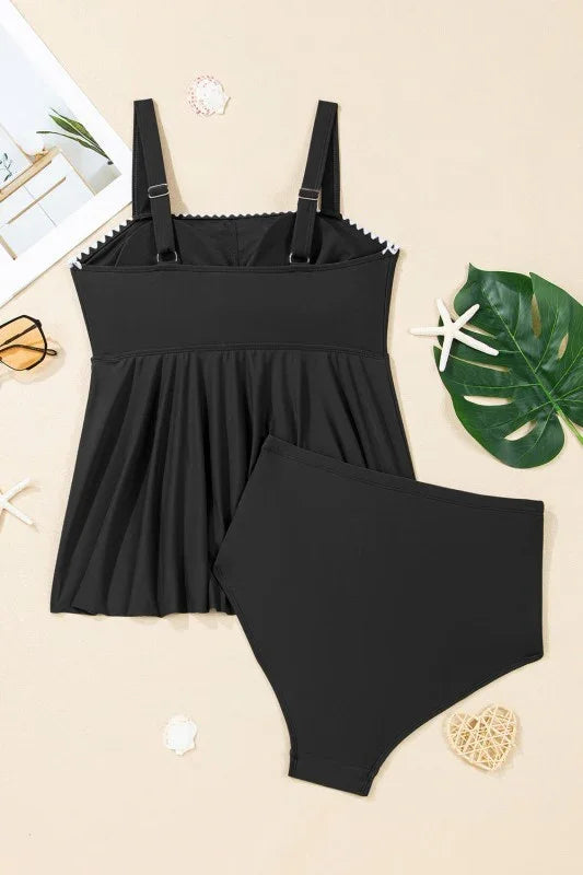 Black plus-size bikini set with ruffled top and high-waisted bottoms, styled with tropical leaves and starfish.