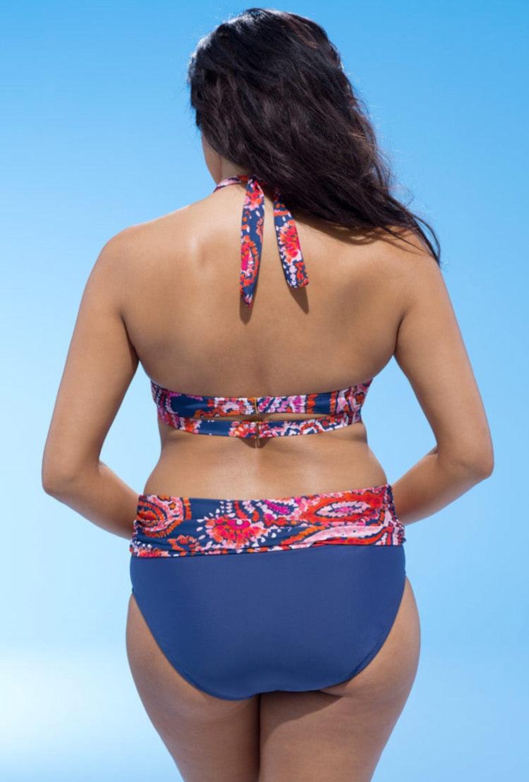 Woman wearing a colorful bikini set against a clear blue sky