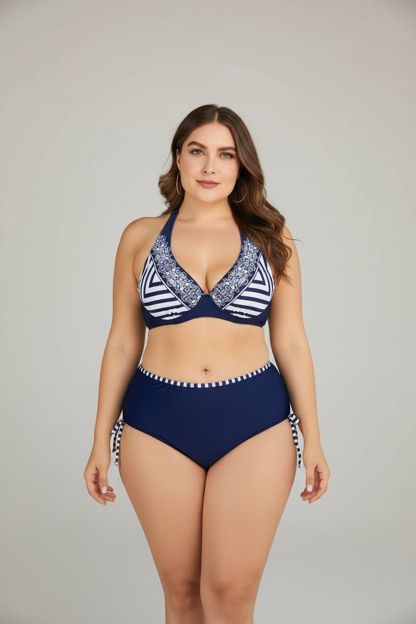Woman wearing a navy and white striped bikini with a white background