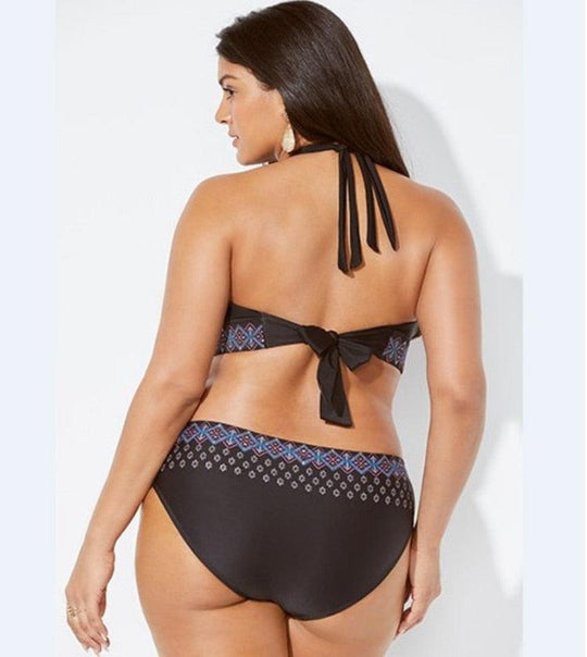 Woman wearing a black bikini with patterned design on a white background