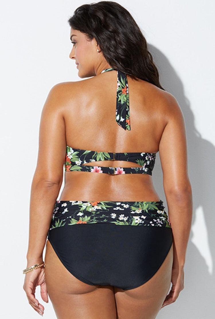 Woman wearing a black floral bikini against a white background