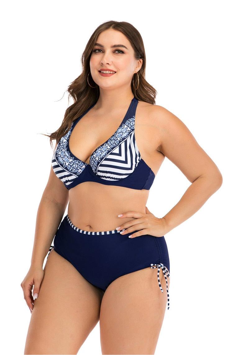 Woman wearing a navy blue and white patterned bikini on a white background